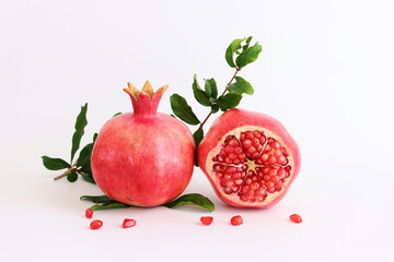 Rosh hashanah (jewish New Year holiday) concept. Pomegranate traditional symbol over white background