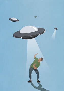 UFO light hovering over afraid man
