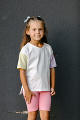 little girl in white t-shirt. space for your logo or design. Mockup for print