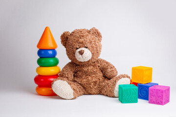 teddy bear with cubes and a pyramid, toys on a white background