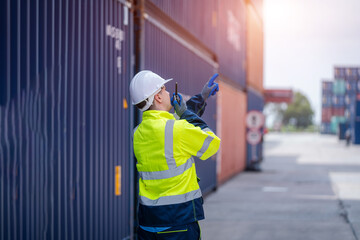 Inspector checking container yard Organising stock to pack into containers,Logistic shipping yard business,Unload and loading variety of products to and from container