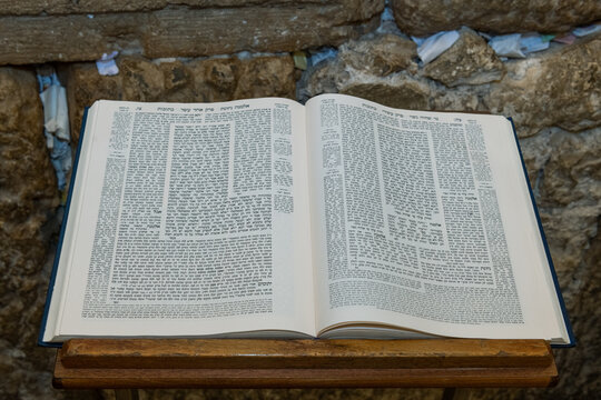 A Talmud open to the text from the tractate Ketubot rests on a prayer stand in front of the Western Wall in Jerusalem.