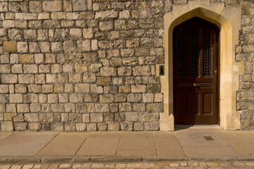 Fototapeta na wymiar Detail castle wall medieval stone door background