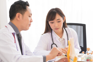 Fototapeta premium Group of Asian doctor meeting and discuss with other colleagues in modern office clinic room.