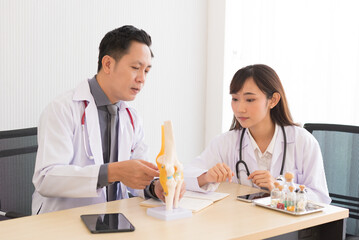 Group of Asian doctor meeting and discuss with other colleagues in modern office clinic room.