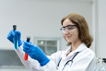Medical scientists working with scientific equipment in the laboratory. Female scientist doing analysis liquid in glassware tube in the lab office
