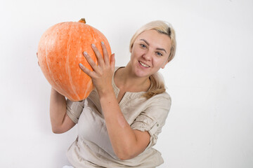 Portrait of beautiful young blonde woman with pumpkin ready for halloween celebration, mockup for postcard and invitation or advertisement