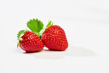 Two strawberries on a white background