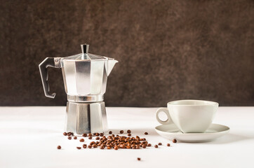 coffee beans, mocha coffee maker and white cup