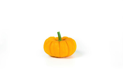 Cute orange pumpkin isolated on white background. Decorative squash side view with copy space. The concept of diet organic food for vegetarians.