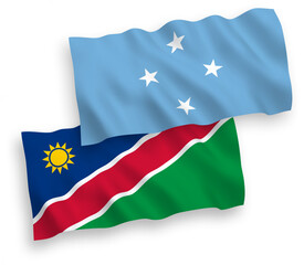 Naklejka premium National vector fabric wave flags of Federated States of Micronesia and Republic of Namibia isolated on white background. 1 to 2 proportion.