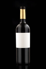 A bottle of red expensive wine on a black background vertical close-up photo. blank label copy space
