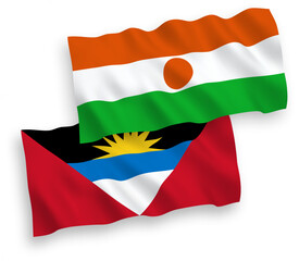 National vector fabric wave flags of Republic of the Niger and Antigua and Barbuda isolated on white background. 1 to 2 proportion.