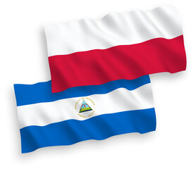 National vector fabric wave flags of Nicaragua and Poland isolated on white background. 1 to 2 proportion.