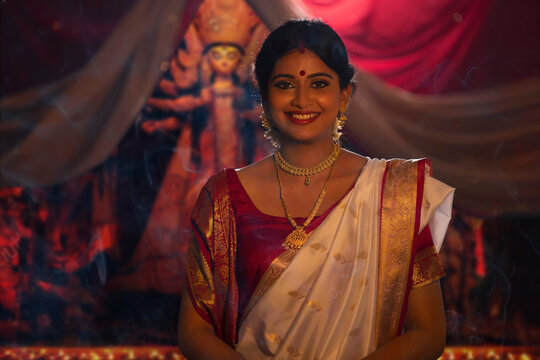 Portrait of young Bengali woman in traditional outfit on the occasion of Durga Puja