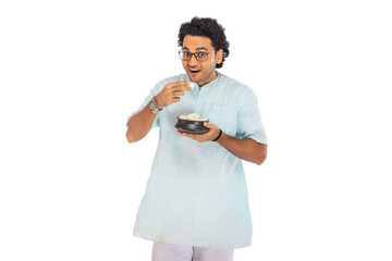 Portrait of Bengali man having rosogolla