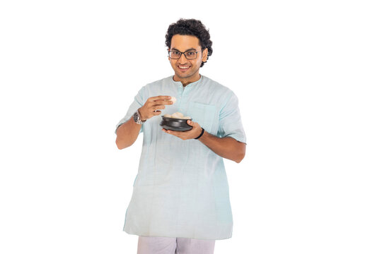 Portrait of Bengali man standing with a rosogolla handi