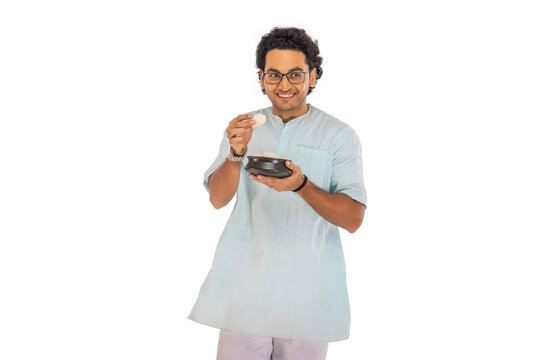 Portrait of Bengali man standing with a rosogolla handi