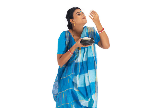 Portrait of Bengali woman having rosogolla