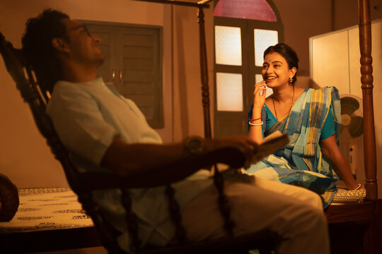 Portrait of Bengali couple talking in bedroom