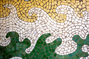 Detail of a beautiful abstract decoration of a building decorated with wave-shaped ceramic mosaics. Venetian mosaic as a decorative background. Mosaic ceramic stones for decorating pool walls.