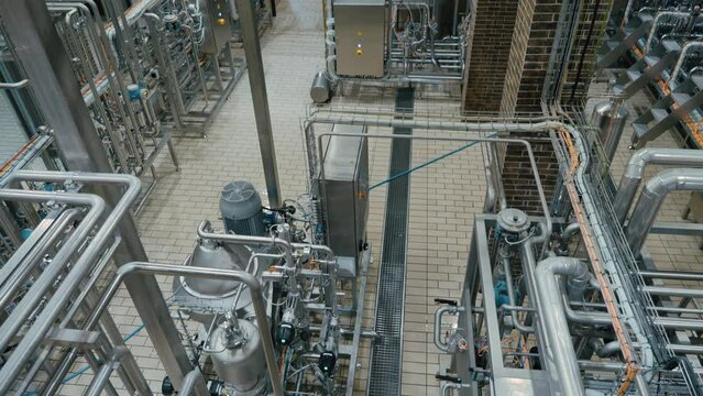 Modern craft brewery with steel pipelines, tanks reservoirs and technique equipment. Craft beer production.