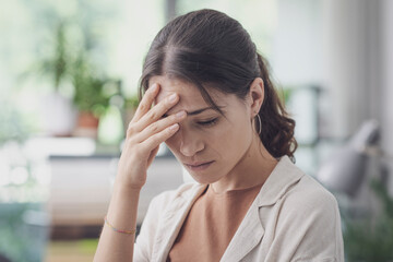 Stressed sad woman posing indoors