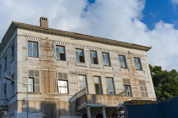 Fototapeta premium Full Facade of an Old White Wooden Bosphorus Mansion with Symmetrical Windows and Cloudy Sky