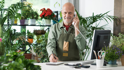 Professional florist taking orders over the phone