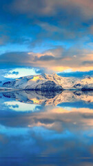 sunset over water and mountain
