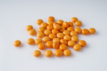 orange valerian pills on a white acrylic background