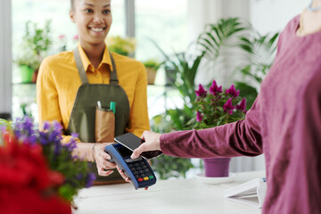 Customer paying using her smartphone