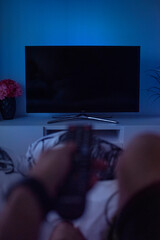 Watching TV from bed. Black screen TV mockup.