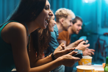 Cheerful friends playing video games together - Powered by Adobe