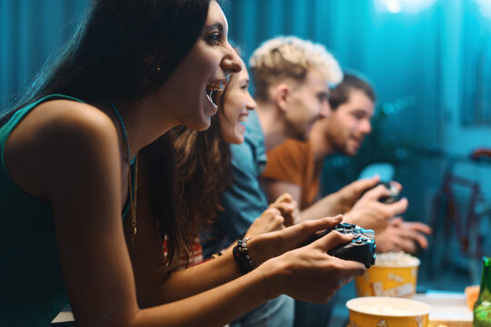 Cheerful friends playing video games together