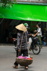 Vietnamese woman selling fruit and vegetables on the street. Traditional sale. Hanoi