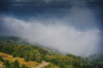 Beautiful summer mountain landscape, clouds over a small village in a mountain gorge in Serbia