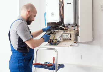 Qualified engineer servicing a boiler