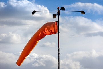 Orange windsock at an airport	