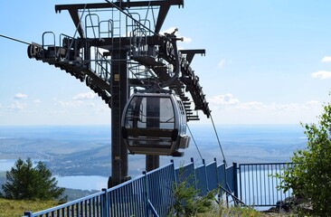 An empty cabin of the gondola ski lift near the support on a summer day © Rinat Akhtiamov