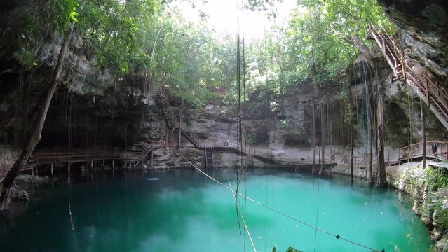 View of Xcanche cenote in Yucatan, Mexico. Beautiful Mexican natural landscape with water sinkhole and jungle