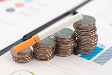 A cigarette is on a coin tobacco price increase