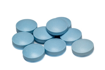 heap of blue pills on white background