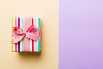 holiday paper present tied pink ribbon bow top view with copy space. Flat lay holiday background. Birthday or christmas present. Christmas gift box concept with copy space