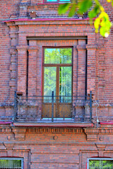 Fragment of the facade of a historic building on a summer day