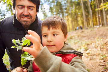 Forester and child with oak leaves in arboriculture class