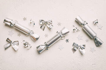 Christmas crackers with shiny confetti on color background, top view, copy space