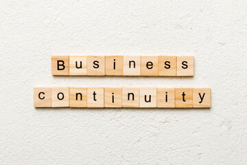 Business Continuity word written on wood block. Business Continuity text on cement table for your desing, concept