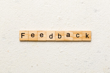 feedback word written on wood block. feedback text on cement table for your desing, concept