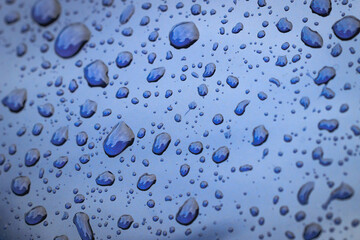 Close up on a raindrops on car body surface